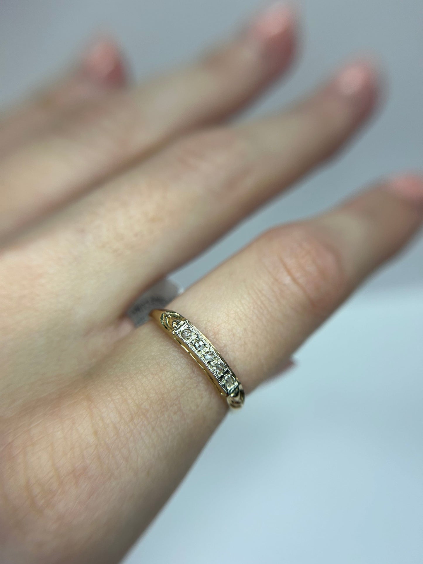 a close up of a person's hand with a ring on it