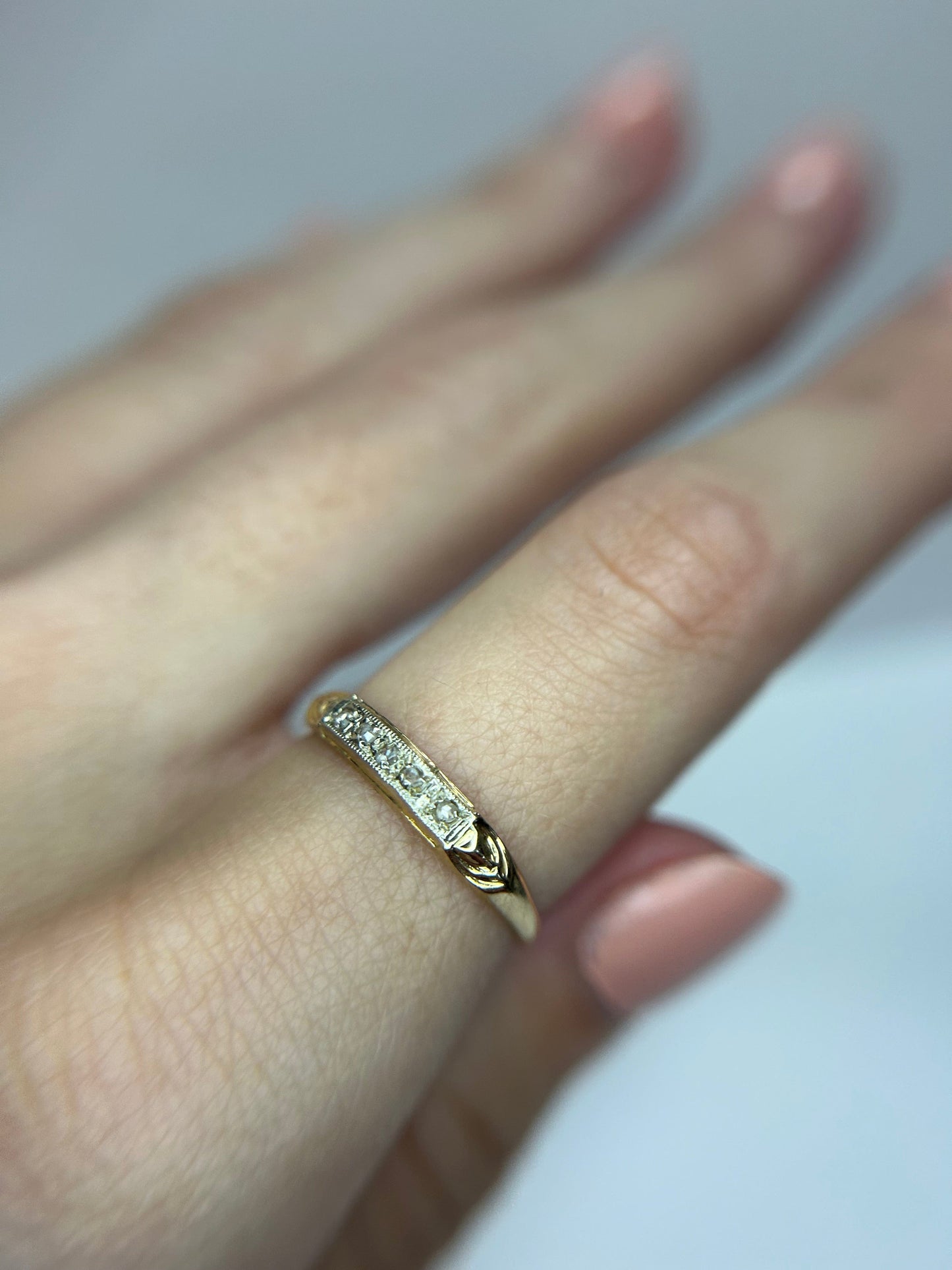 a close up of a person's hand with a ring on it