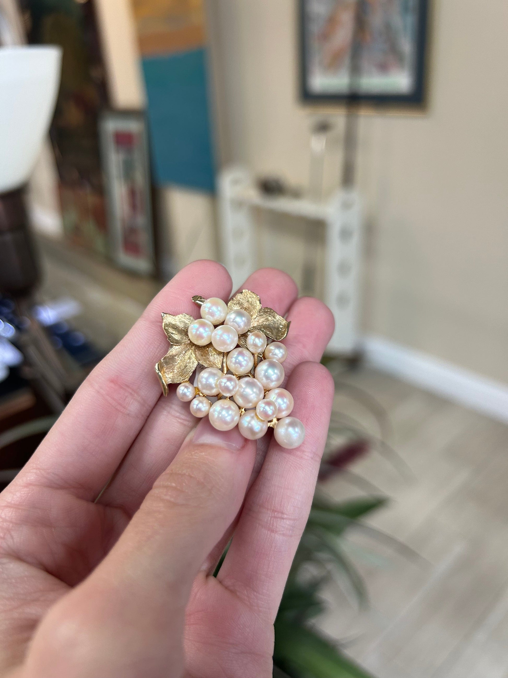 a person holding a bunch of pearls in their hand