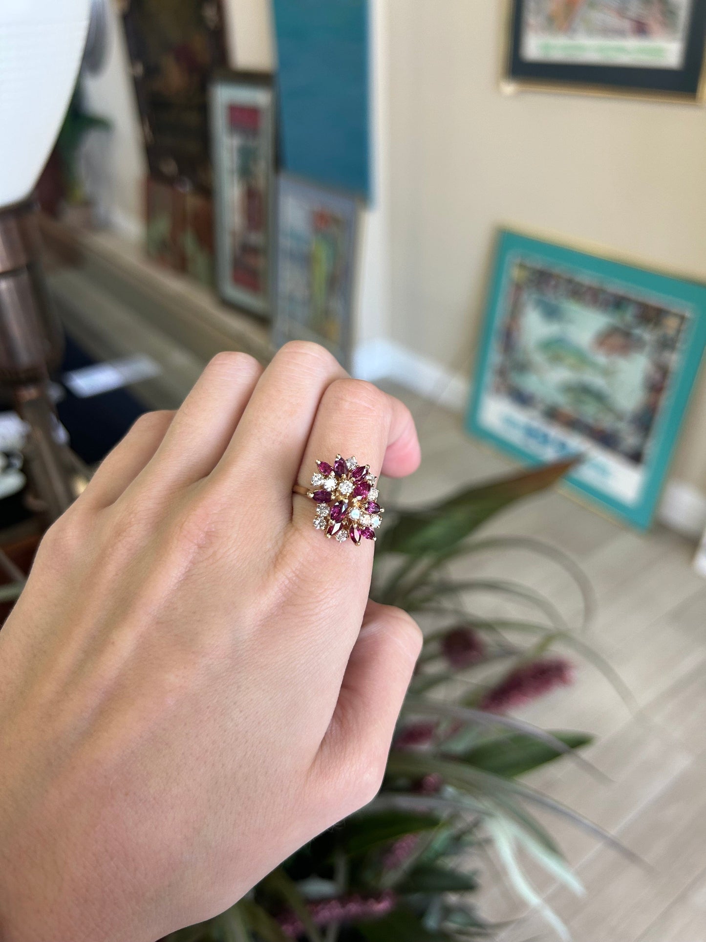 a woman's hand holding a ring with three stones