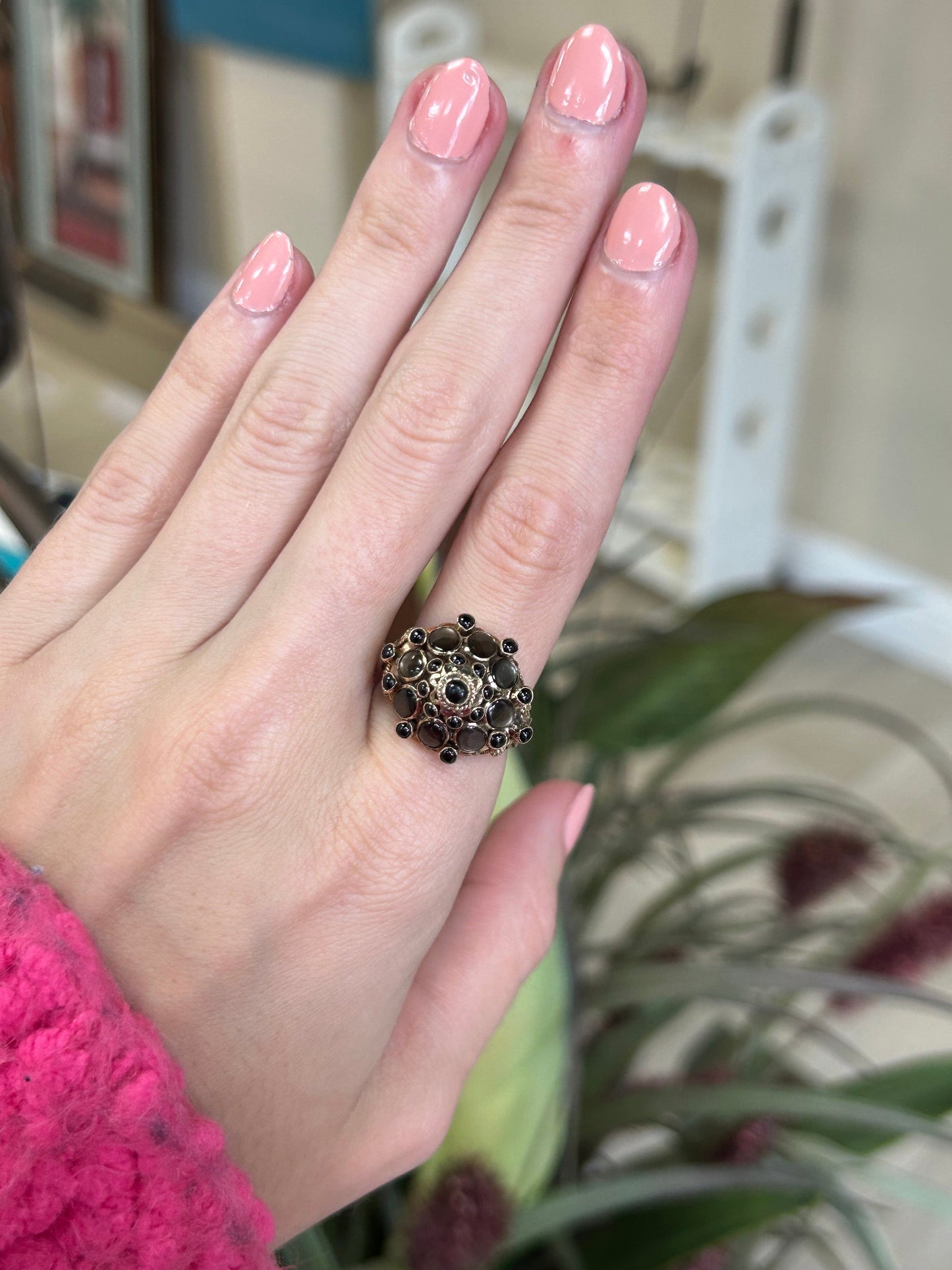 a close up of a person's hand with a ring on it