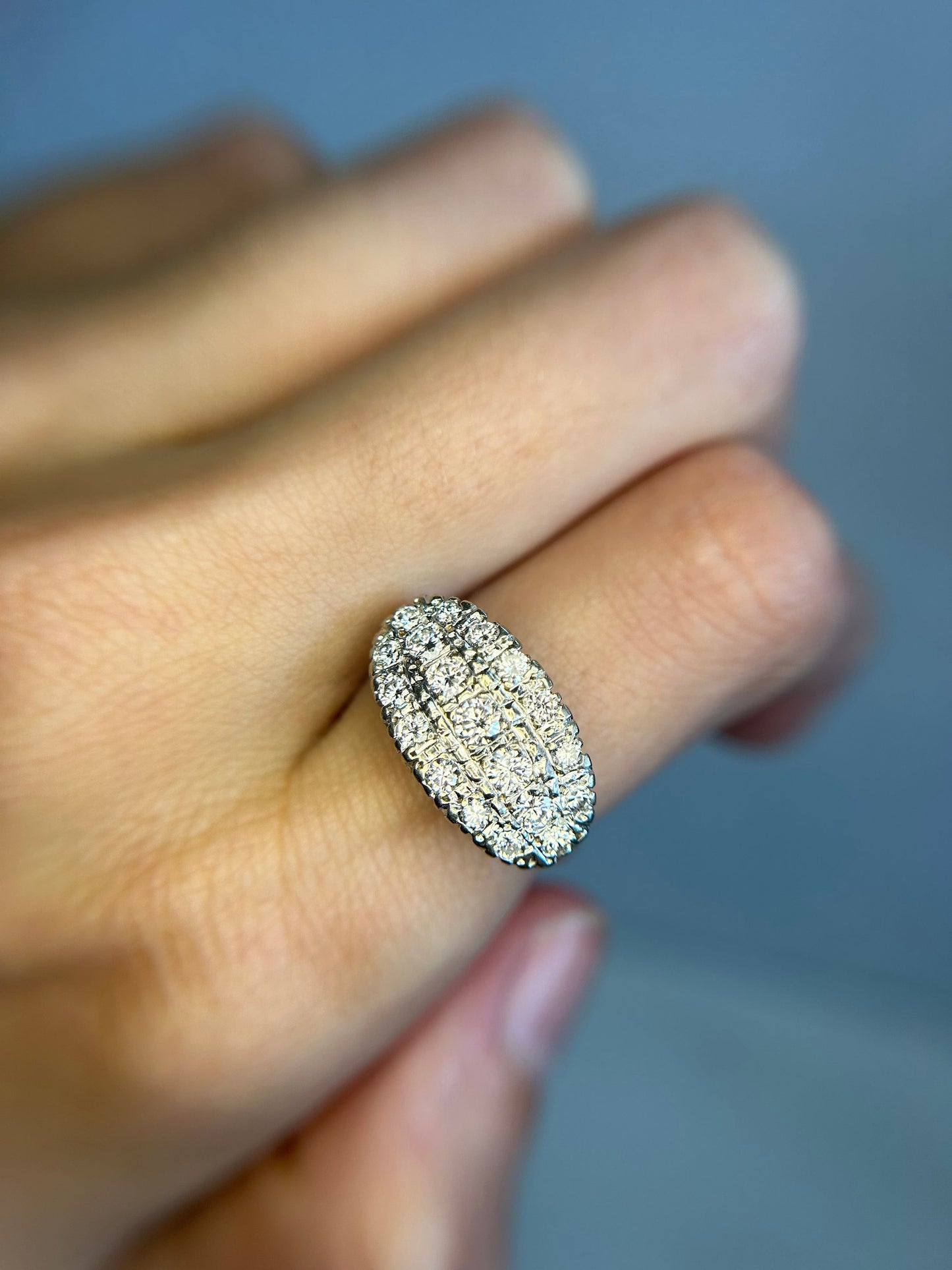 a close up of a person's hand holding a ring