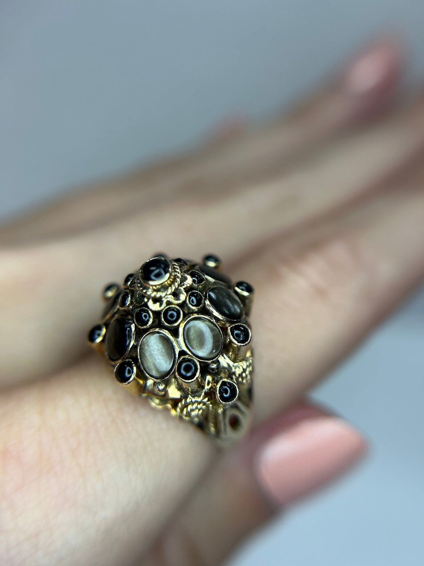 a close up of a person's hand with a ring on it