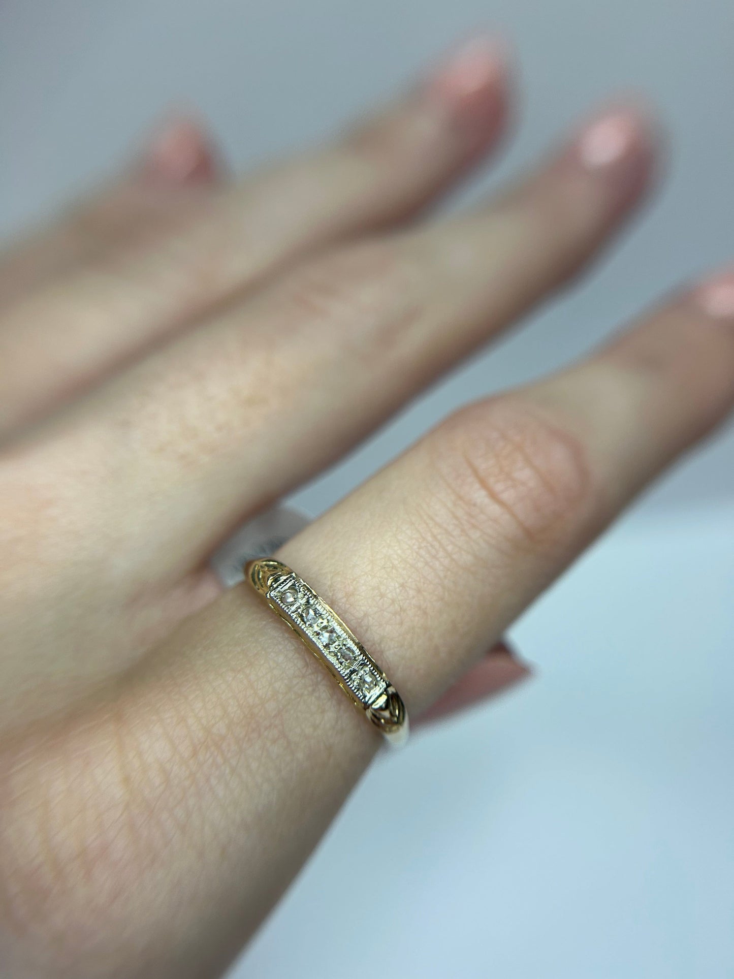 a close up of a person's hand with a ring on it