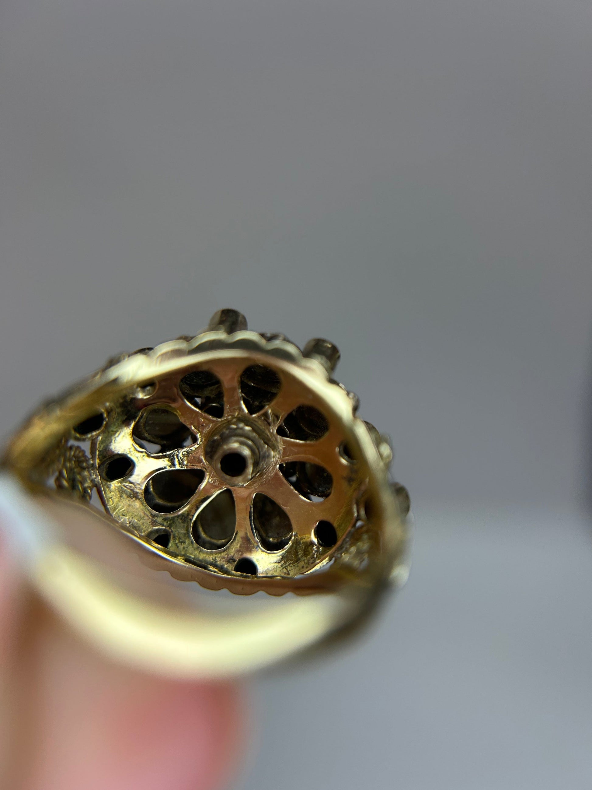 a close up of a person holding a gold ring