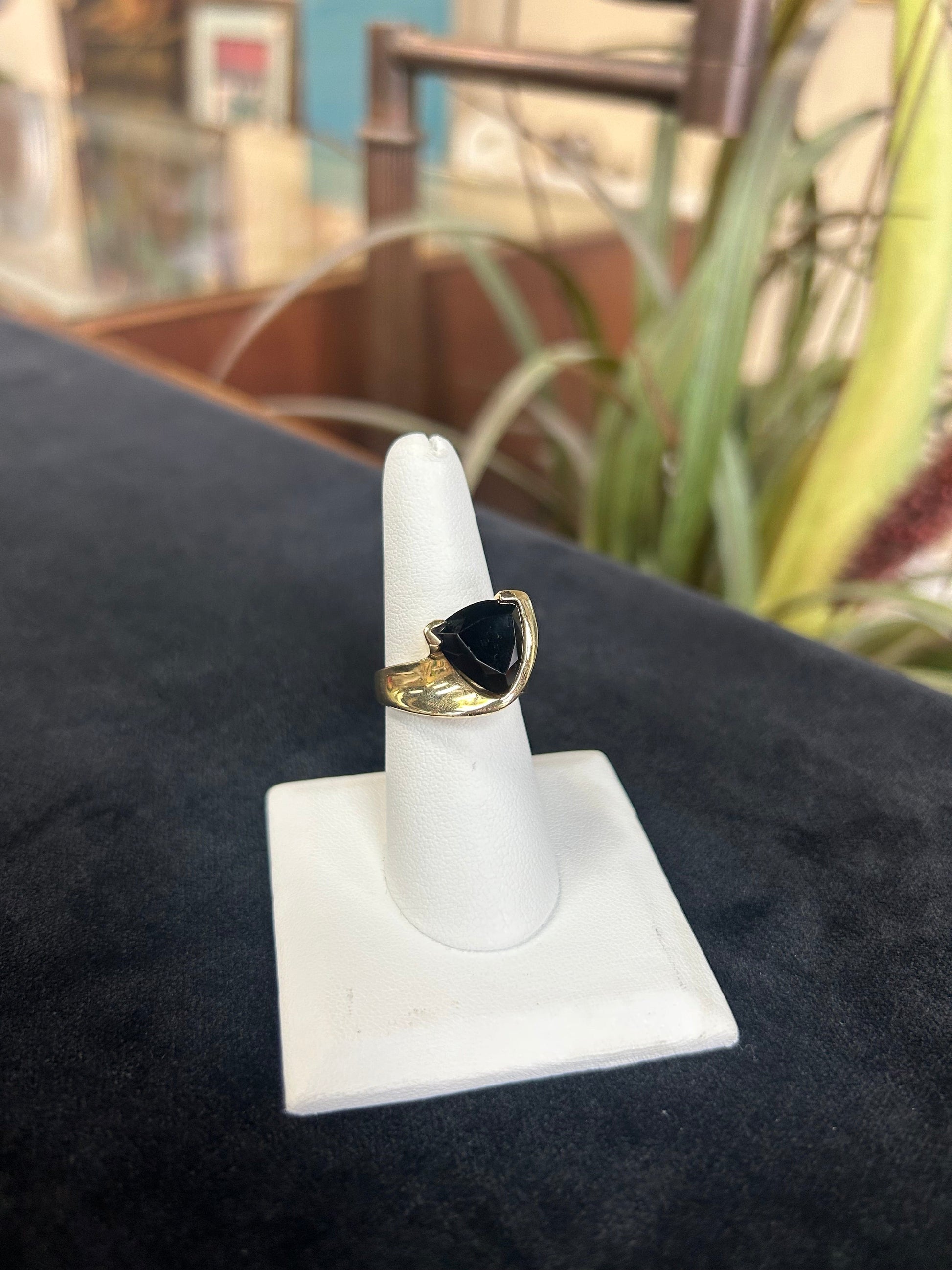 a gold ring with a black stone on it