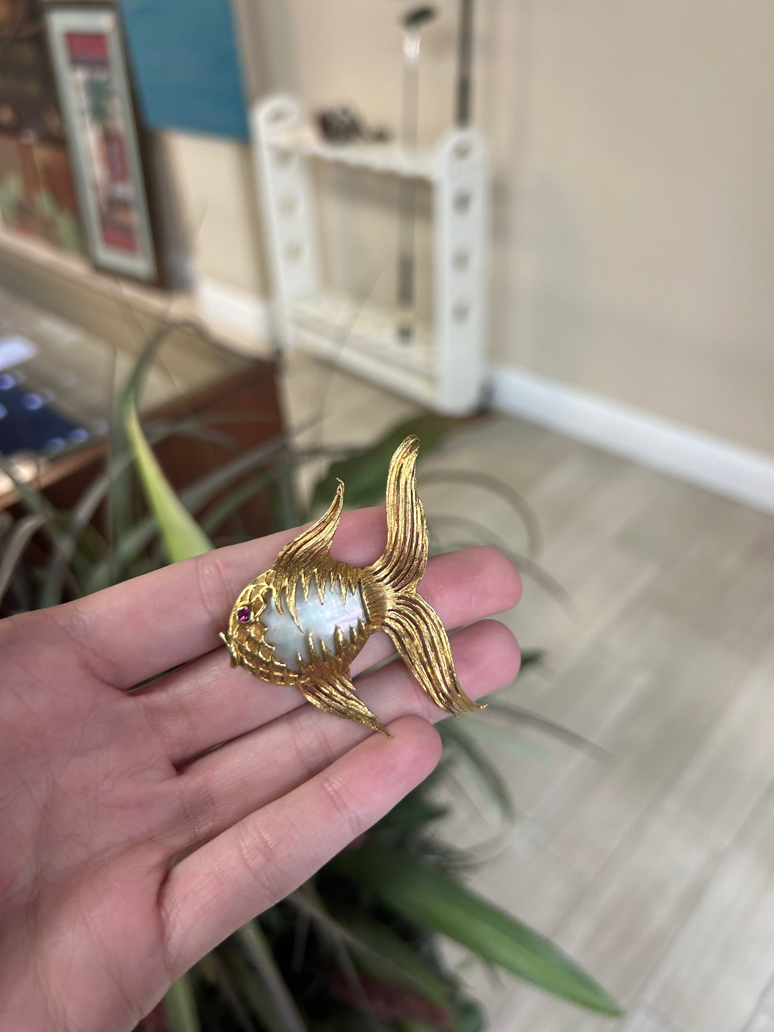 a person holding a ring with a bird on it