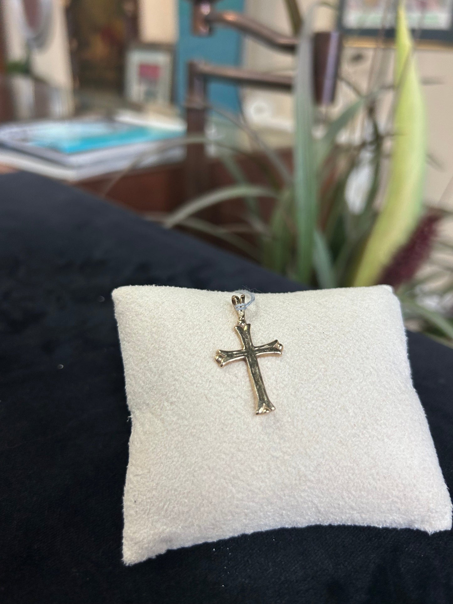 a close up of a pillow with a cross on it