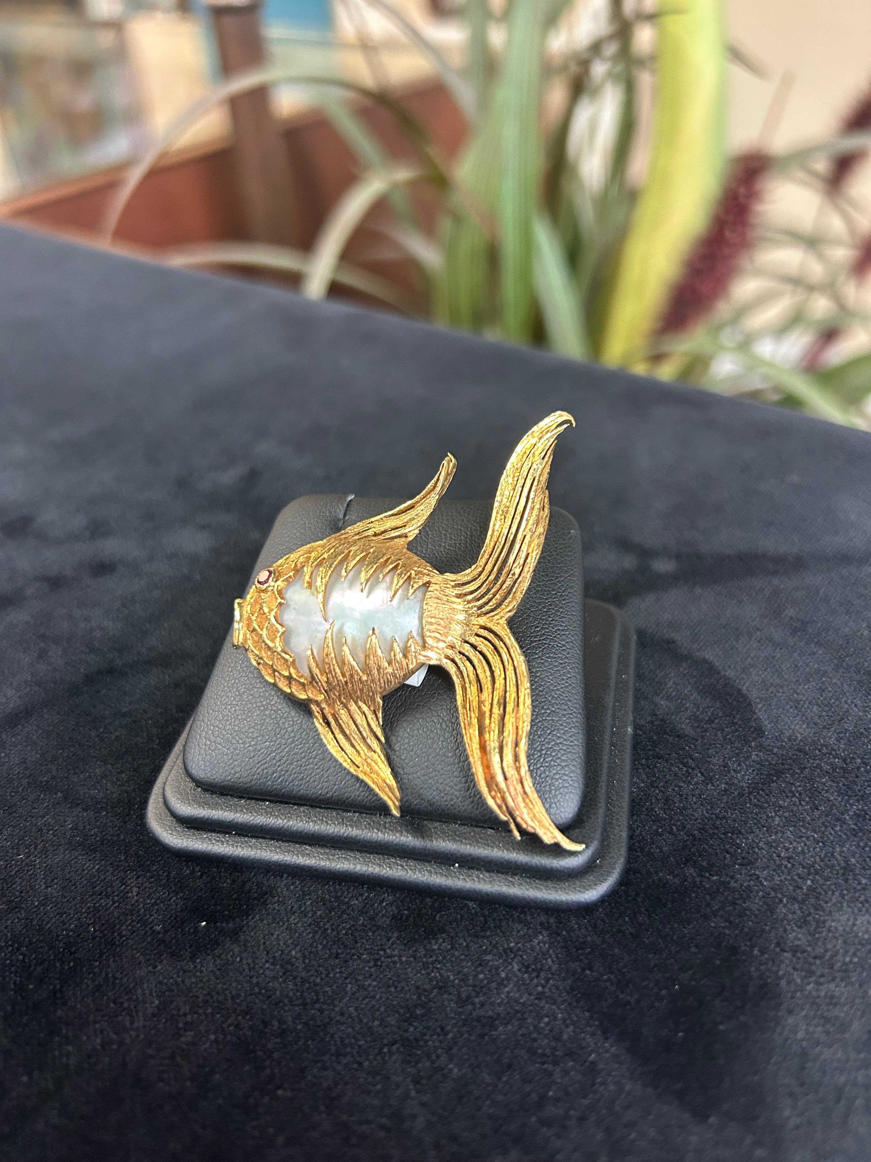 a close up of a gold brooch on a black jacket