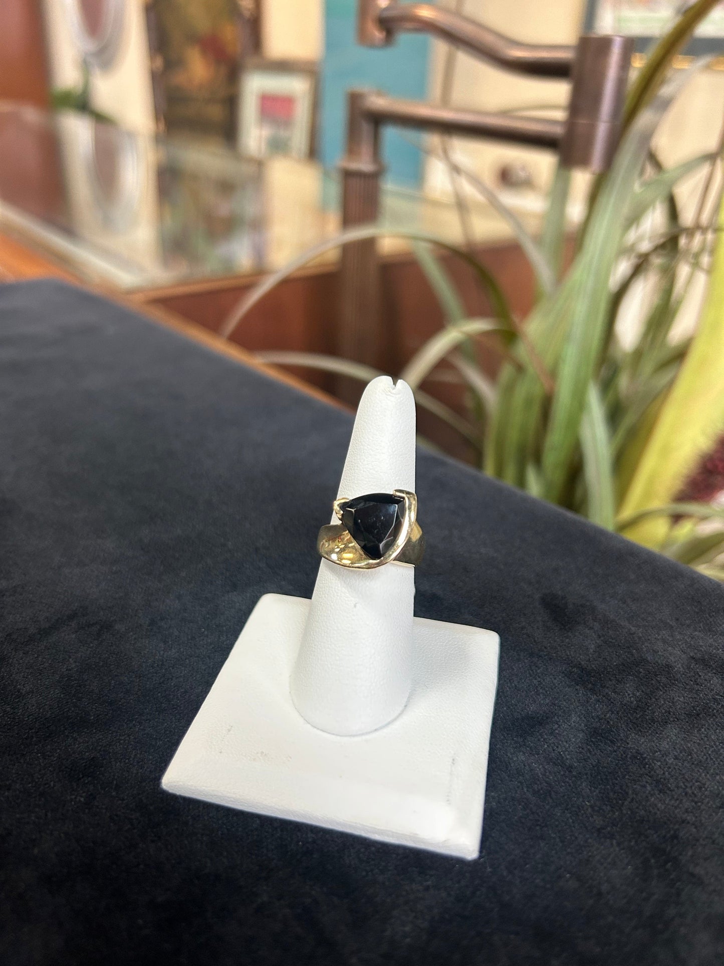 a black and gold ring on a white wall