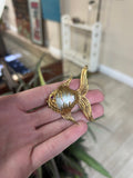 a person holding a ring with a bird on it