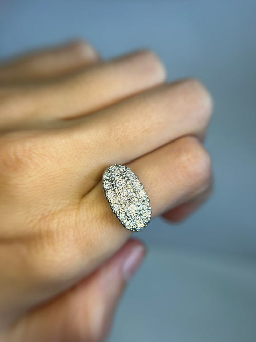 a close up of a person's hand holding a diamond ring